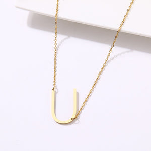 slanted initial necklace gold / u