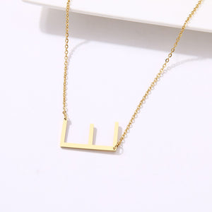 slanted initial necklace gold / e