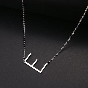 slanted initial necklace silver / e